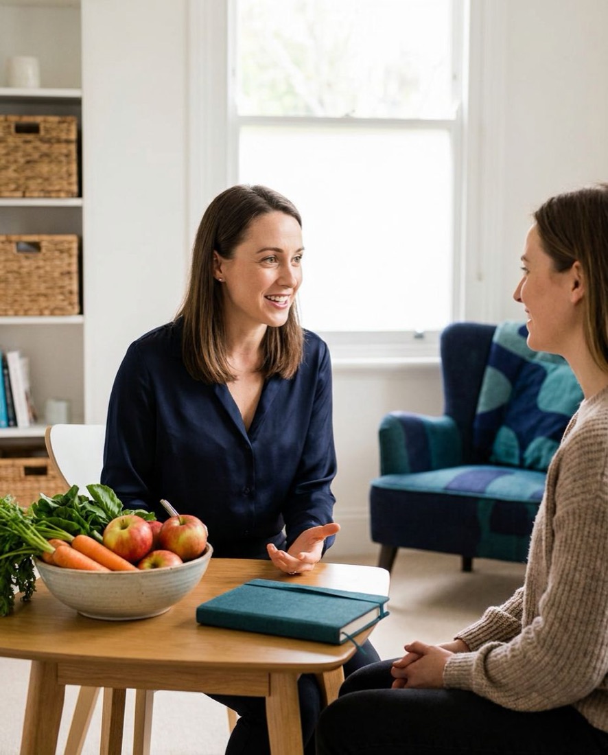 A dietitian talking with a client across a table
